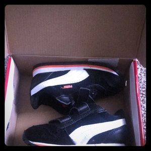 Size 7c Black Orange& white Pumas w/ Velcro straps